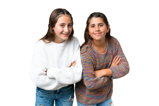 Friends girls over isolated chroma key background keeping the arms crossed while smiling