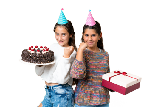 Friends girls holding gift and a birthday cake over isolated chroma key background celebrating a victory