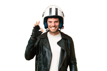 Brazilian man with a motorcycle helmet over isolated chroma key background showing ok sign with fingers