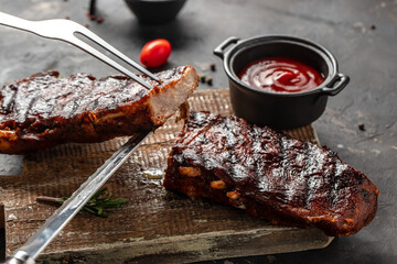 Grilled and smoked ribs with barbeque sauce. Delicious barbecued ribs. Food recipe background....