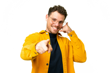 Brazilian man over isolated chroma key background making phone gesture and pointing front