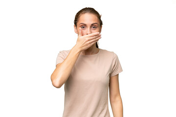 Young caucasian woman over isolated background covering mouth with hand