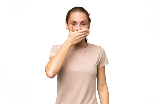 Young caucasian woman over isolated background covering mouth with hand