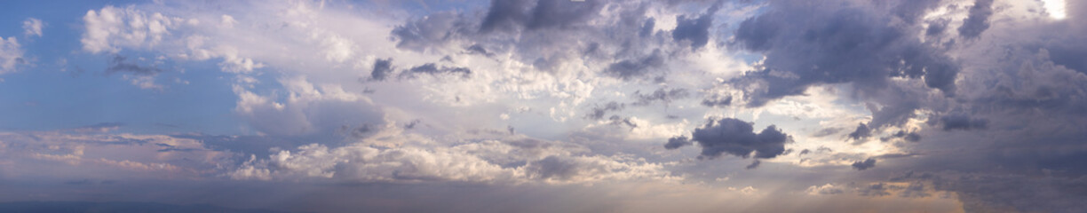 Naklejka na ściany i meble Blue sky with gray clouds at daytime 
