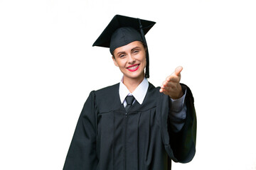 Young university graduate  caucasian woman over isolated background shaking hands for closing a...