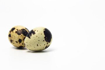 Obraz premium Quail Eggs Kissing Each Other, Pareidolia Effect on Quail eggs. Right Copy Space. Isolated on White