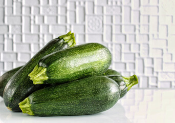 Zucchini is young. Fresh, green, ripe vegetables on a white background. Italian squash, selective focus.
