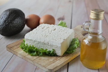 tofu, olive oil and avocado on table 
