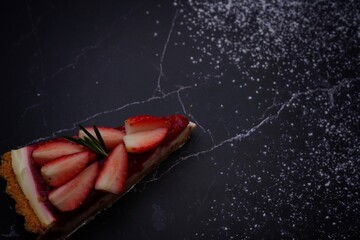 Photo of strawberry cake on a black background