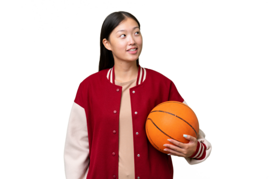 Young basketball player asian woman over isolated background thinking an idea while looking up