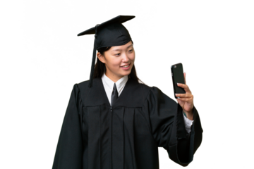 Young university graduate Asian woman over isolated background making a selfie