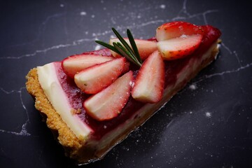 Photo of strawberry cake on a black background