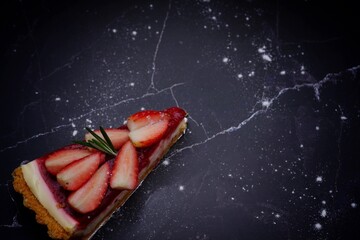 Photo of strawberry cake on a black background