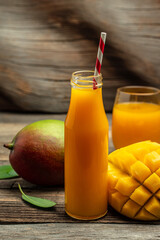 Fresh tropical fruit smoothie mango juice in a glass jar with a tube. place for text