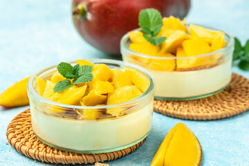 Mango Panna cotta, Mango desserts with pieces of fresh mango on a light background. top view