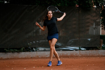 Ready to hit. Beautiful female tennis player with racket ready to hit a tennis ball.