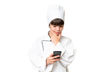 Little caucasian chef girl over isolated background thinking and sending a message