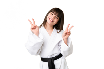 Little Caucasian girl doing karate over isolated background showing victory sign with both hands
