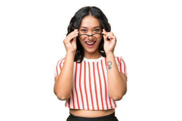 Young Argentinian woman over isolated background with glasses and surprised