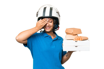 Young Argentinian deliver fast food over isolated background has realized something and intending the solution