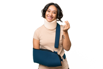 Young argentinian woman wearing neck brace and sling over isolated background making money gesture