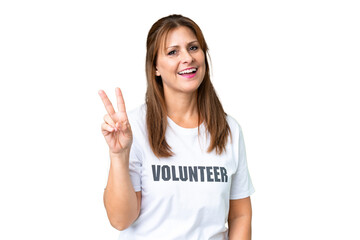 Middle age volunteer woman over isolated background smiling and showing victory sign