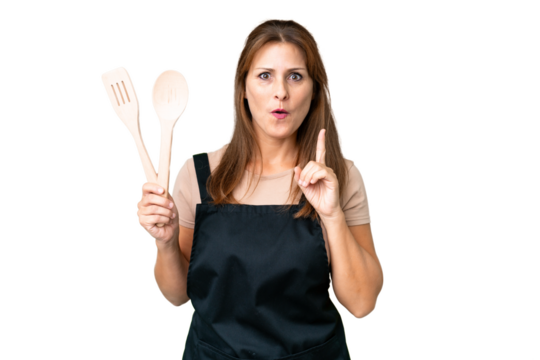Middle age caucasian woman holding a rolling pin over isolated background intending to realizes the solution while lifting a finger up