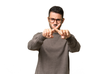 Young handsome caucasian man over isolated background making stop gesture with her hand to stop an act