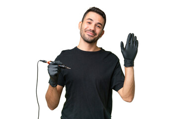 Tattoo artist caucasian man over isolated background saluting with hand with happy expression