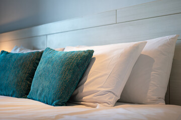 Green and white pillows set in contemporary design in the bedroom. Interior decoration and object...