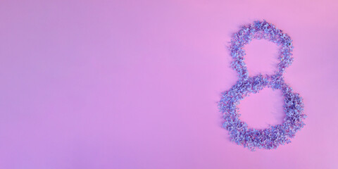 Figure 8 made of flowers on pink background. Happy International Womens Day celebrate on March, congratulatory card