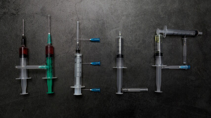The word help is laid out from used syringes. The concept of drug dependence, drug use, drug...