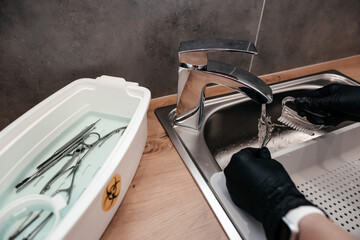 wash manicure tools under running water, disinfection of manicure tools after the procedure,...