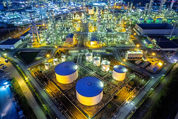 Oil refinery plant from industry zone, Aerial view oil and gas industrial, Refinery factory oil storage tank at night.