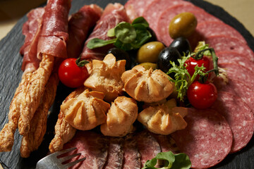 sausage slices on a plate. salami. anitpasti, appetizers, buffet,