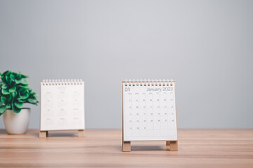 Desktop calendar for 2023 on a desk beige and white background. plans and goals on next year. Two Calendars 2023 on office table. Plan on next year concept.