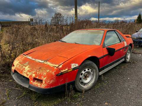 Miercurea Ciuc, Romania- 25 December 2022: Old , abandoned Pontiac Fiero near roadside.