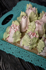 Zephyr tulips. Natural homemade marshmallow. Arranged on a tray. Close-up.