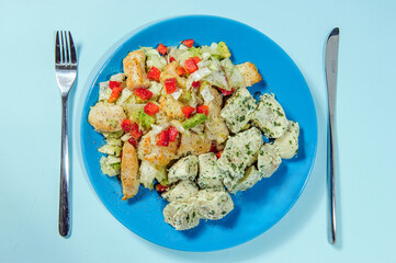 Breaded chicken breast with potato salad.Studio shot.