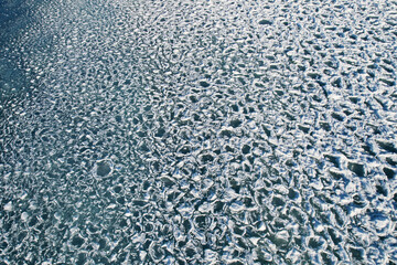 Ice floes in the water. Abstract nature background.
