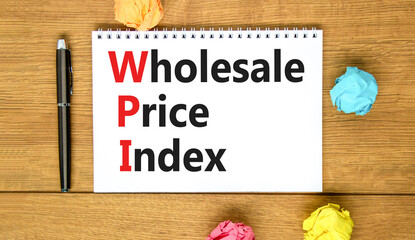 WPI wholesale price index symbol. Concept words WPI wholesale price index on white note on a beautiful wooden background. Business WPI wholesale price index concept. Copy space.