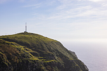 Amazing lighthouse on a high cliff on the Madeira coast in Portugal.