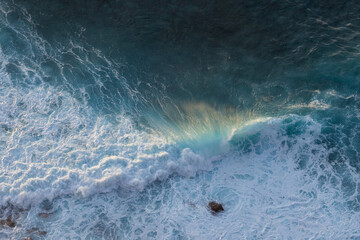 Great waves in the Atlantic Ocean that are illuminated by the sun and therefore shine so beautifully.