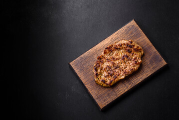 Delicious juicy grilled pork steak with spices and herbs