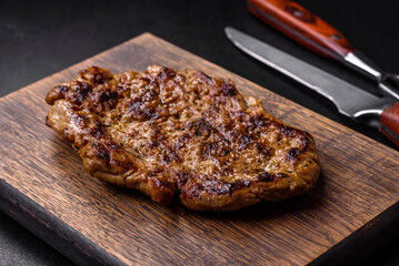 Delicious juicy grilled pork steak with spices and herbs