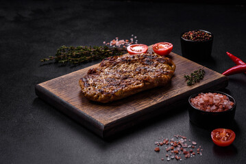 Delicious juicy grilled pork steak with spices and herbs