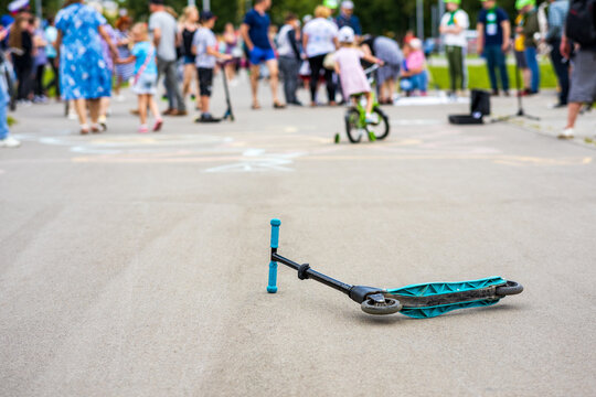 a scooter lying on the pavement after a collision. road accident involving a scooter
