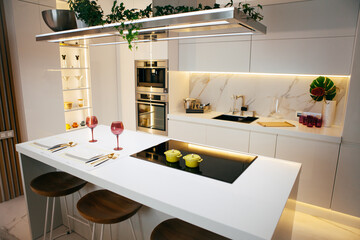 Modern kitchen interior with two plates and glasses on the table