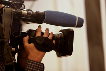 Anonymous cameraman with television camera