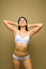 Fototapeta premium Athletic woman relaxing and looking happy in her underwear